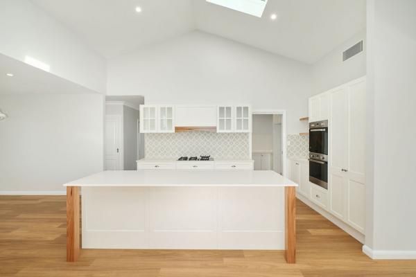 An Empty Kitchen with White Cabinets and Wooden Floors | Mid-North Coast, NSW | BDM Constructions