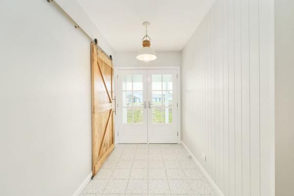 A Hallway with White Walls and A Sliding Barn Door | Mid-North Coast, NSW | BDM Constructions