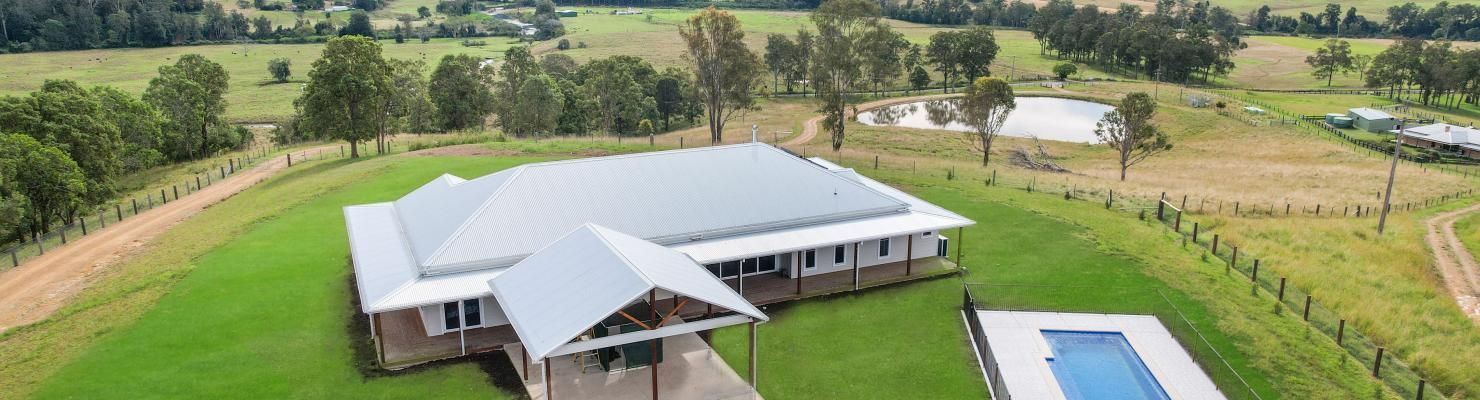 An Aerial View of A House with A Pool in The Middle of A Field | Mid-North Coast, NSW | BDM Construc