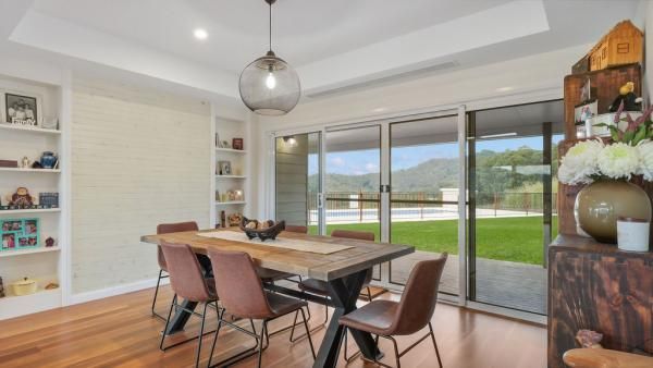 A Dining Room with A Table and Chairs and A Sliding Glass Door | Mid-North Coast, NSW | BDM Constructions
