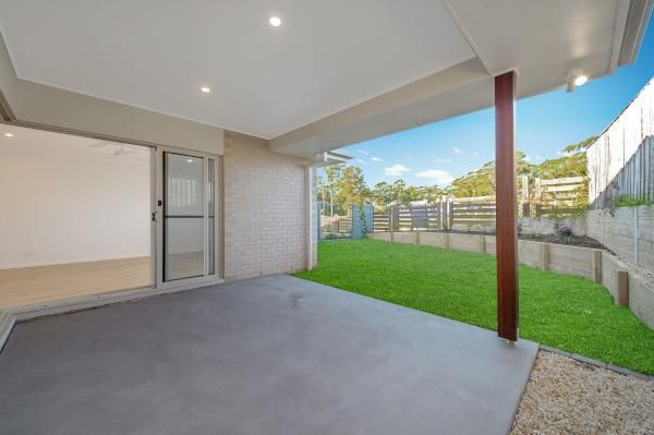 An Empty Patio with A Sliding Glass Door and A Fence in The Background | Mid-North Coast, NSW | BDM Constructions
