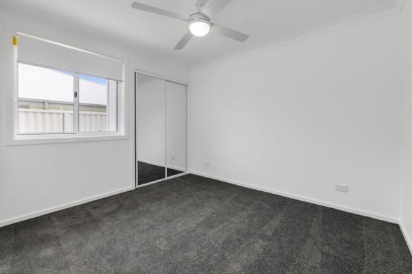 An Empty Bedroom with A Ceiling Fan and A Window | Mid-North Coast, NSW | BDM Constructions