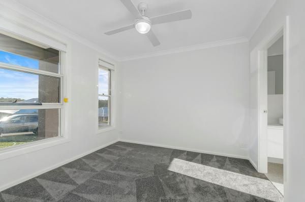 An Empty Bedroom with A Ceiling Fan and Two Windows | Mid-North Coast, NSW | BDM Constructions