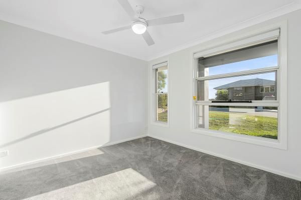 An Empty Bedroom with A Ceiling Fan and Two Windows | Mid-North Coast, NSW | BDM Constructions