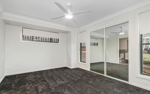 A Bedroom with A Lot of Mirrors and A Ceiling Fan | Mid-North Coast, NSW | BDM Constructions