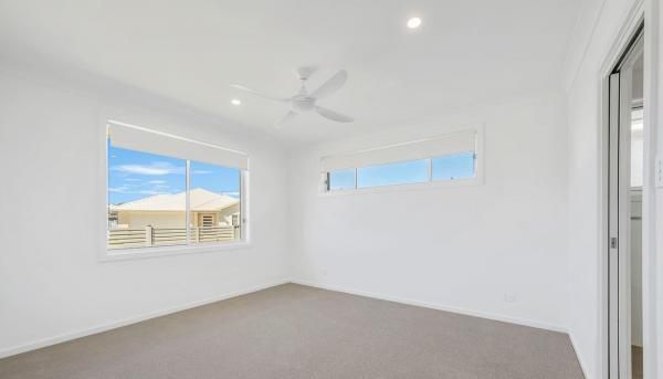 An Empty Bedroom with Two Windows and A Ceiling Fan | Mid-North Coast, NSW | BDM Constructions