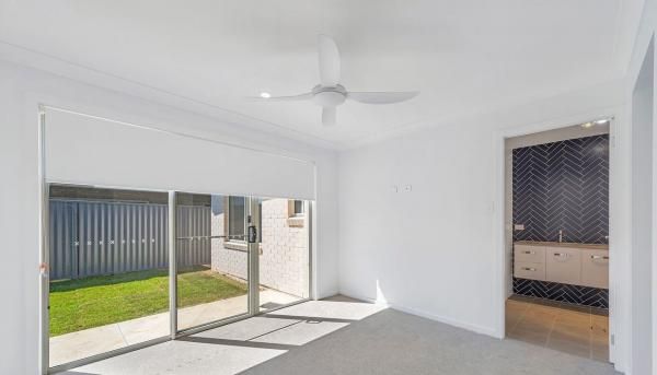 An Empty Room With A Ceiling Fan and Sliding Glass Doors | Mid-North Coast, NSW | BDM Constructions