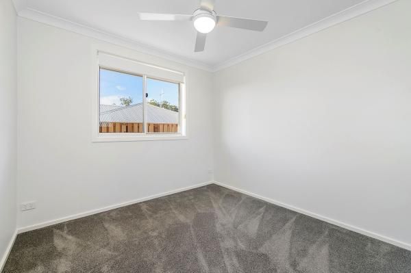 An Empty Bedroom with A Ceiling Fan and A Window | Mid-North Coast, NSW | BDM Constructions