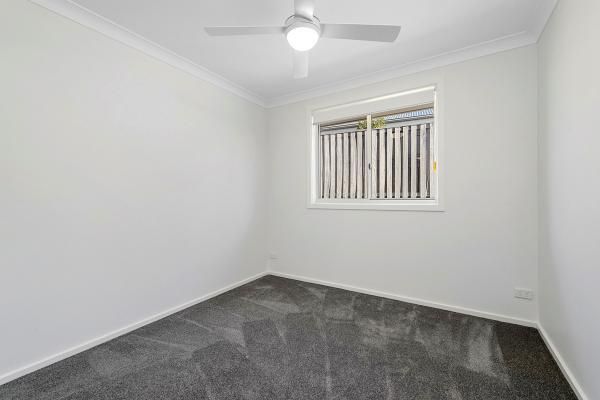 An Empty Bedroom with A Ceiling Fan and A Window | Mid-North Coast, NSW | BDM Constructions