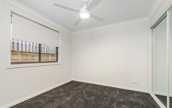 An Empty Bedroom with A Ceiling Fan and A Mirror | Mid-North Coast, NSW | BDM Constructions