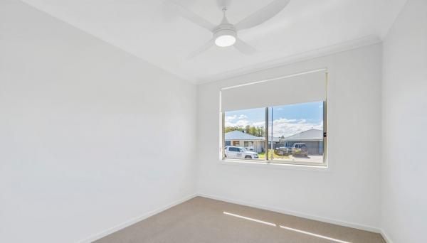 An Empty Bedroom with A Ceiling Fan and A Window | Mid-North Coast, NSW | BDM Constructions