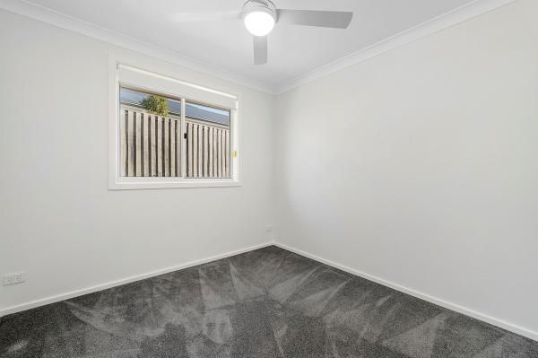 An Empty Bedroom with A Ceiling Fan and A Window | Mid-North Coast, NSW | BDM Constructions