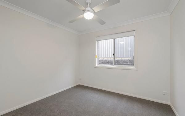 An Empty Bedroom with A Ceiling Fan and A Window | Mid-North Coast, NSW | BDM Constructions