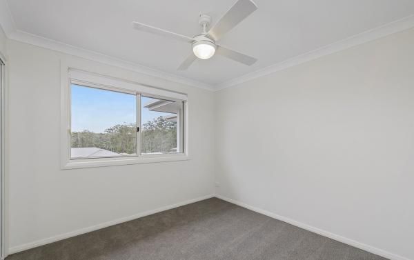 An Empty Bedroom with A Ceiling Fan and A Window | Mid-North Coast, NSW | BDM Constructions