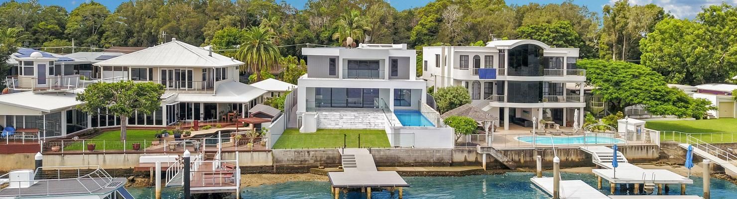A Group of Houses Sitting Next to A Body of Water | Mid-North Coast, NSW | BDM Constructions