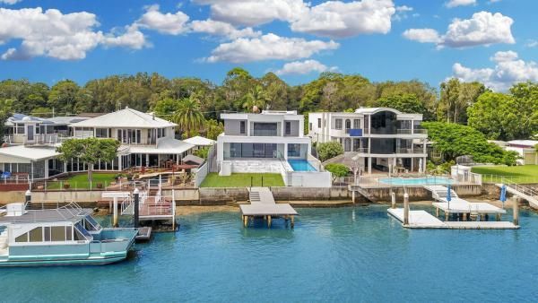 A Group of Houses Are Sitting on Top of A Body of Water | Mid-North Coast, NSW | BDM Constructions