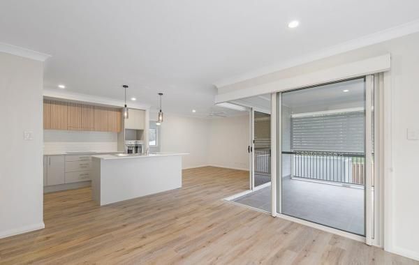 There Is a Sliding Glass Door Between the Kitchen and The Living Room | Mid-North Coast, NSW | BDM Constructions