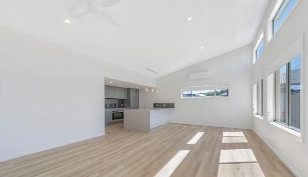 An Empty Living Room With A Vaulted Ceiling and Lots of Windows | Mid-North Coast, NSW | BDM Constructions
