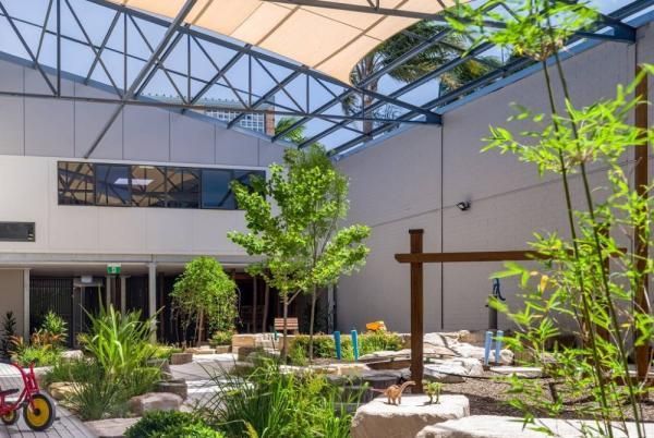 A Bicycle Is Parked in A Courtyard with Trees and Rocks | Mid-North Coast, NSW | BDM Constructions