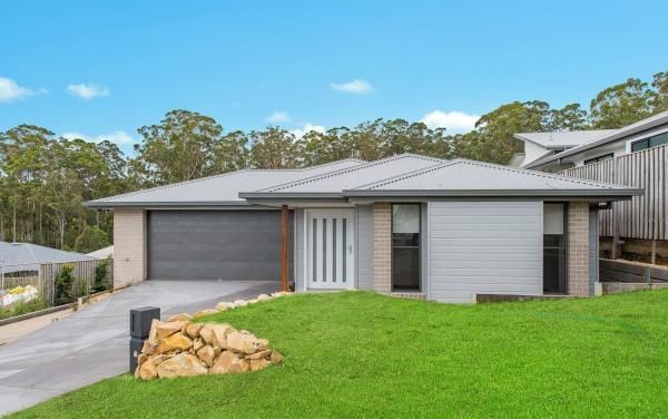 A House with A Garage Is Sitting on Top of A Lush Green Hill | Mid-North Coast, NSW | BDM Constructions