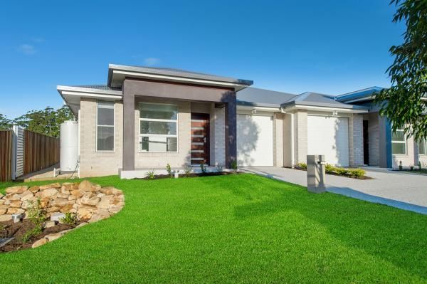 A Modern House with A Lush Green Lawn in Front of It | Mid-North Coast, NSW | BDM Constructions