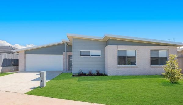 The Front of A House With A Lot of Windows and A Driveway | Mid-North Coast, NSW | BDM Constructions