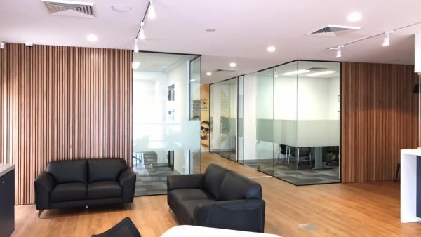 A Living Room with Two Black Couches and A Table | Mid-North Coast, NSW | BDM Constructions