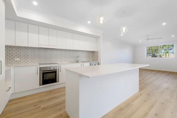 A Kitchen with White Cabinets and A Large Island in The Middle of The Room | Mid-North Coast, NSW | BDM Constructions