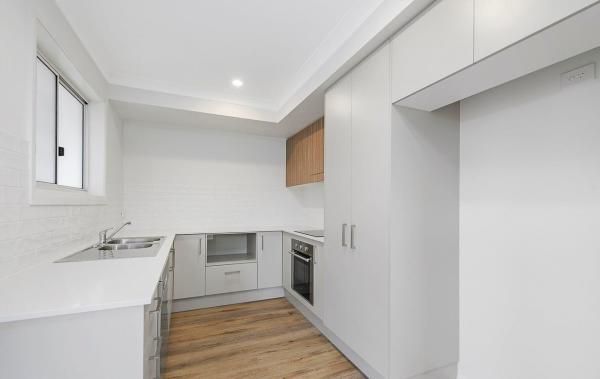 A Kitchen with White Cabinets and Wooden Floors | Mid-North Coast, NSW | BDM Constructions
