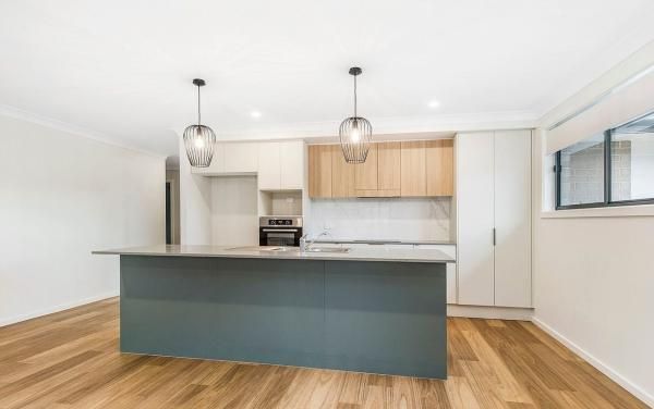 An Empty Kitchen with A Large Island in The Middle | Mid-North Coast, NSW | BDM Constructions