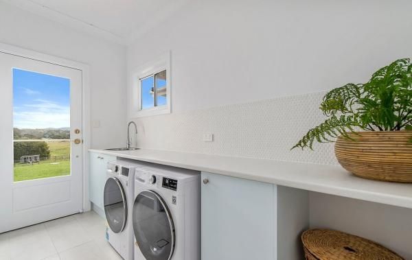 A Laundry Room with A Washer and Dryer and A Window | Mid-North Coast, NSW | BDM Constructions