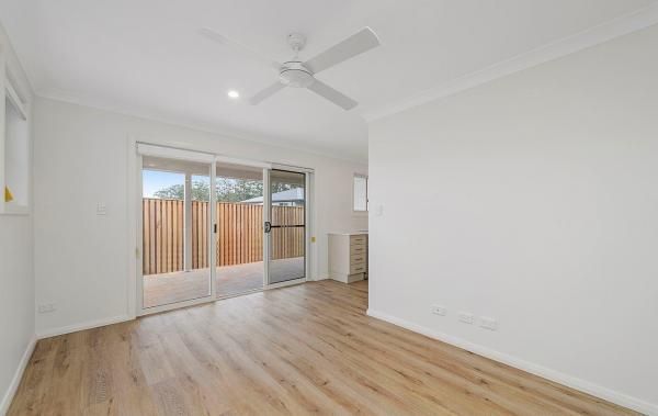 An Empty Living Room with Hardwood Floors and A Ceiling Fan | Mid-North Coast, NSW | BDM Constructions