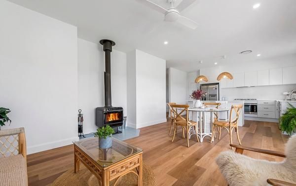 A Living Room with Hardwood Floors and A Wood Stove | Mid-North Coast, NSW | BDM Constructions