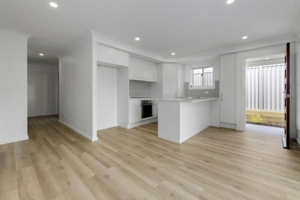 A Living Room with Hardwood Floors and A Kitchen in A House | Mid-North Coast, NSW | BDM Constructions