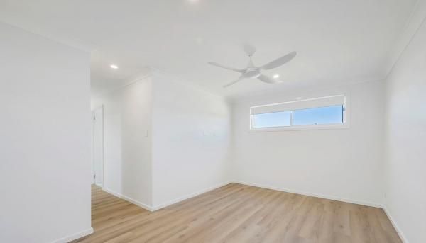An Empty Room With A Ceiling Fan and A Window | Mid-North Coast, NSW | BDM Constructions
