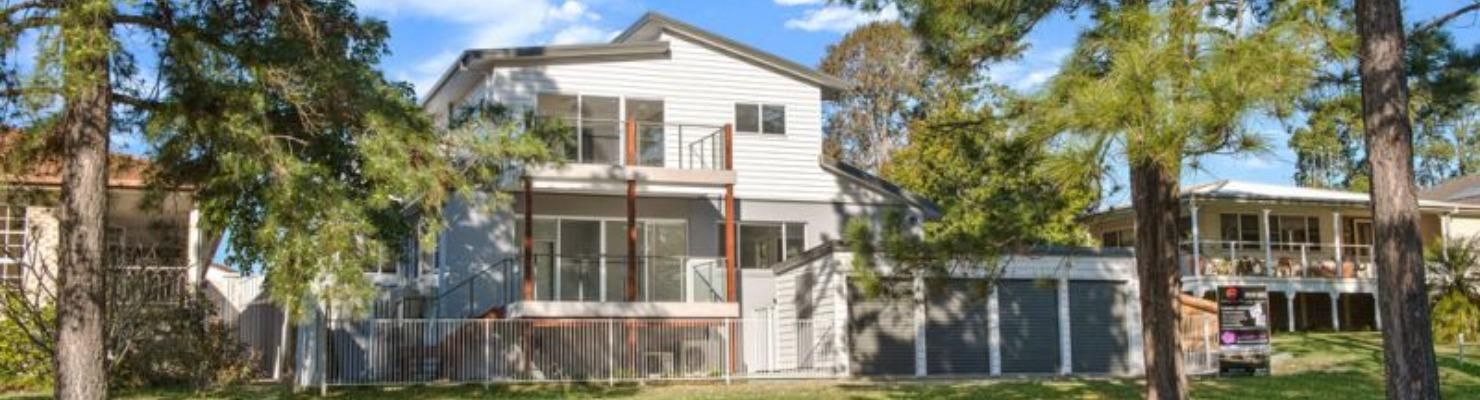 A Large White House Is Surrounded by Trees on A Sunny Day | Mid-North Coast, NSW | BDM Constructions