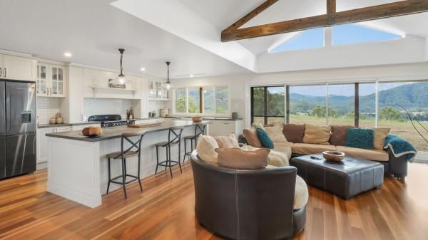 A Living Room with A Couch, Chair, Coffee Table and A Kitchen | Mid-North Coast, NSW | BDM Constructions