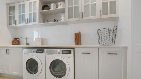 A Laundry Room with A Washer and Dryer and White Cabinets | Mid-North Coast, NSW | BDM Constructions