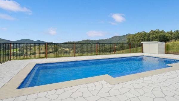A Large Swimming Pool with Mountains in The Background | Mid-North Coast, NSW | BDM Constructions