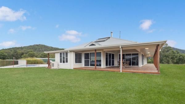 A House with A Large Lawn in Front of It and Mountains in The Background | Mid-North Coast, NSW | BDM Constructions