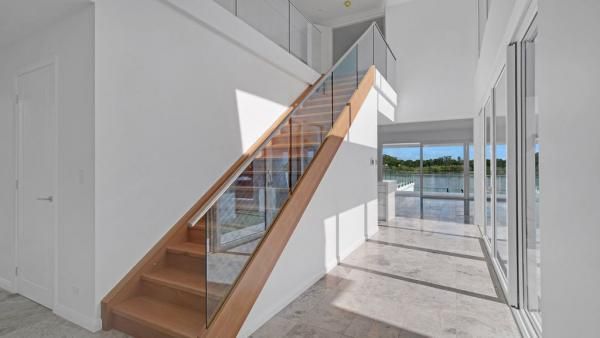 A Wooden Staircase with A Glass Railing in A House | Mid-North Coast, NSW | BDM Constructions
