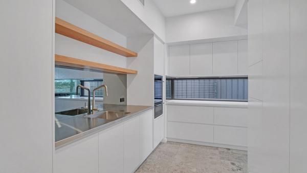 A Kitchen with White Cabinets, a Sink, and A Window | Mid-North Coast, NSW | BDM Constructions