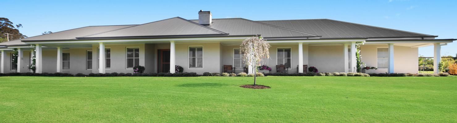 A Large White House with A Porch and A Tree in Front of It | Mid-North Coast, NSW | BDM Constructions