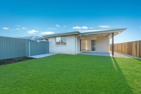 The Backyard of A House with A Large Lawn and A Wooden Fence | Mid-North Coast, NSW | BDM Constructions