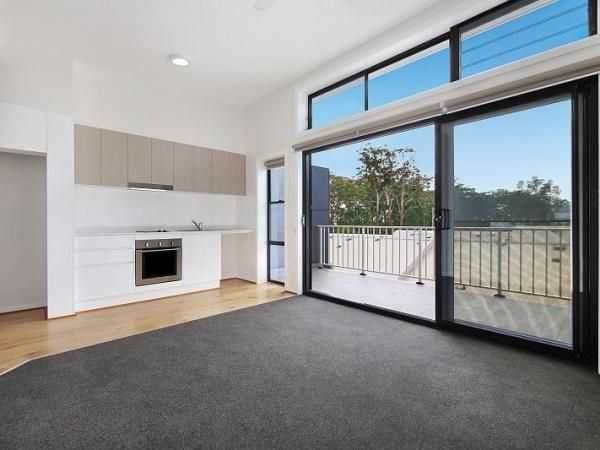 A Living Room with A Sliding Glass Door Leading to A Balcony | Mid-North Coast, NSW | BDM Constructions
