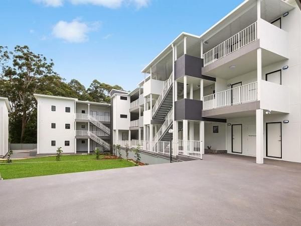 A Large White Apartment Building with Stairs Leading up To the Second Floor | Mid-North Coast, NSW | BDM Constructions
