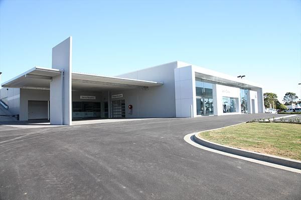 A Large White Building with A Parking Lot in Front of It | Mid-North Coast, NSW | BDM Constructions