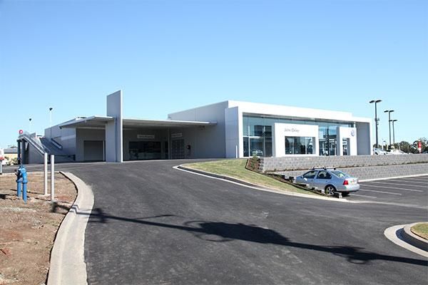 A Car Is Parked on The Side of The Road in Front of A Building | Mid-North Coast, NSW | BDM Constructions