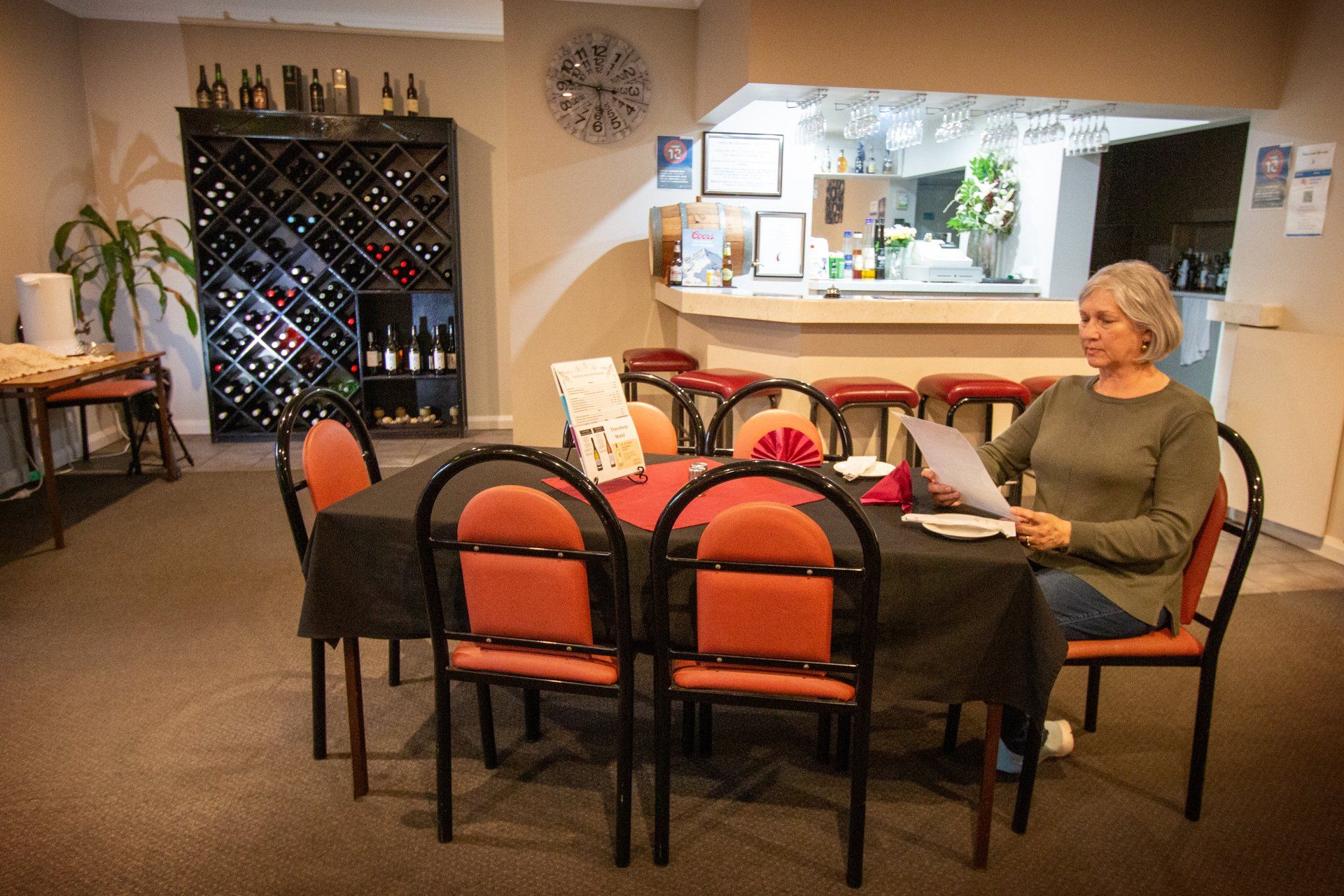 A Woman Checking The Menu - Port Pirie, SA - Travelway Motel