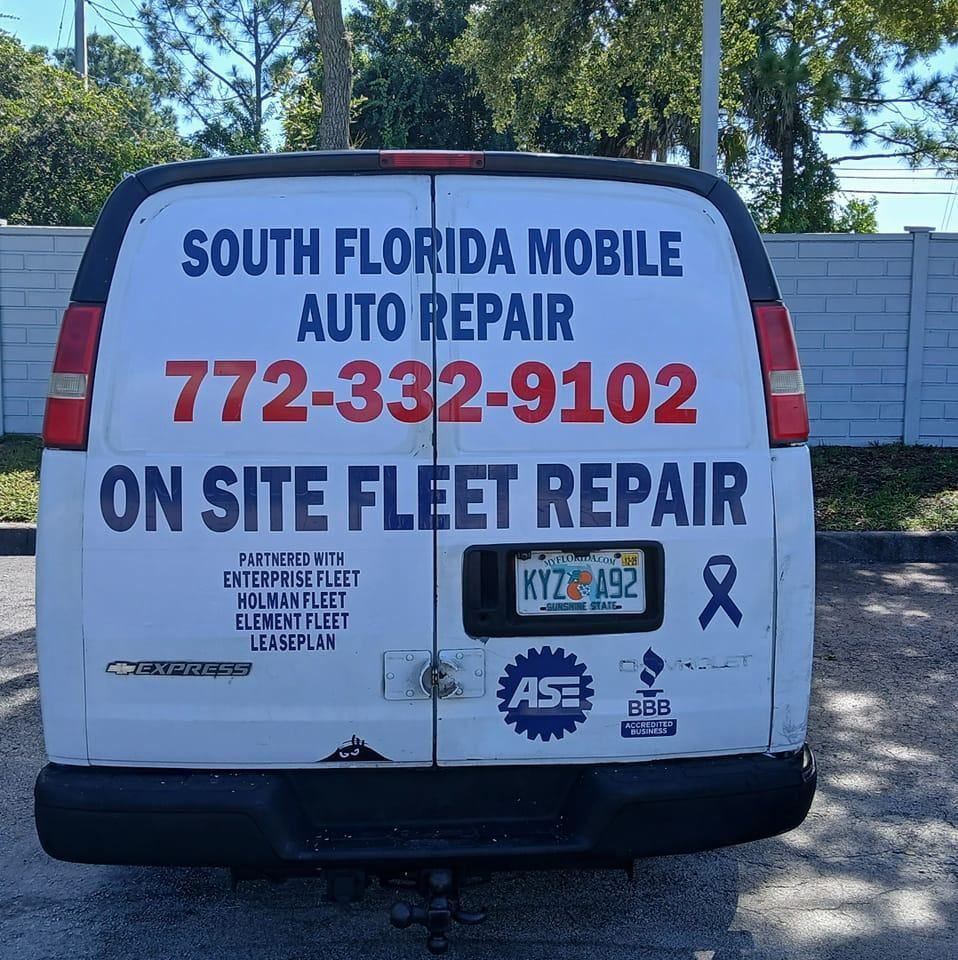A white van that says south florida mobile auto repair on the back.